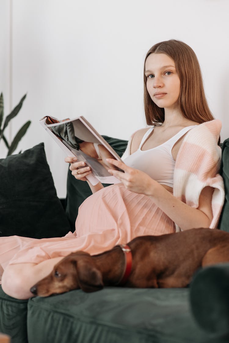 A Pregnant Woman Holding A Magazine