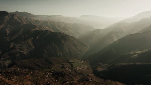 Mountainous terrain with green forest in mist