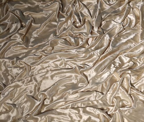 Free A detailed capture of luxurious golden silk fabric with smooth, elegant texture. Stock Photo
