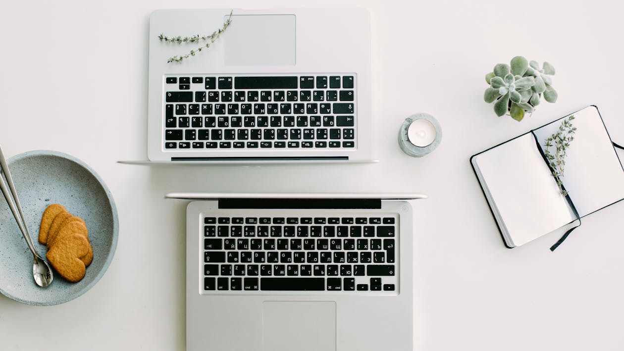 Two Macbook Pro Beside Gray Bowl