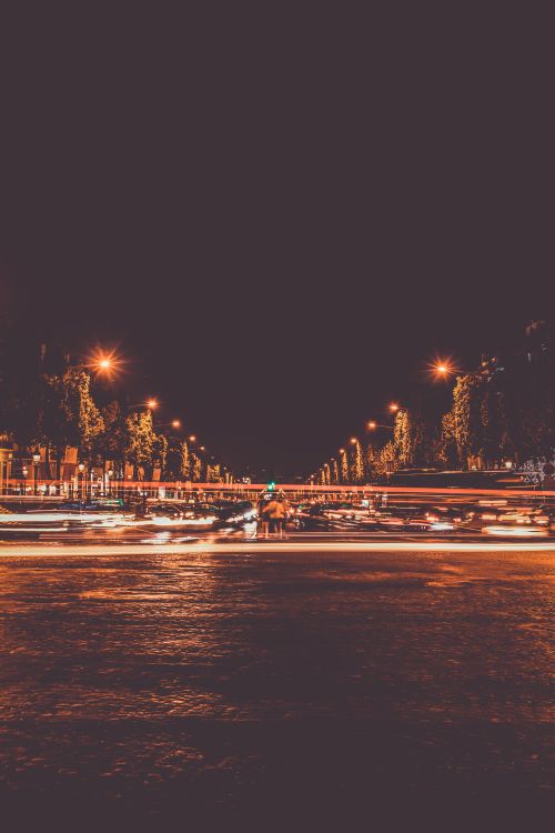 Free Dynamic night scene capturing city lights and urban activity through long exposure. Stock Photo