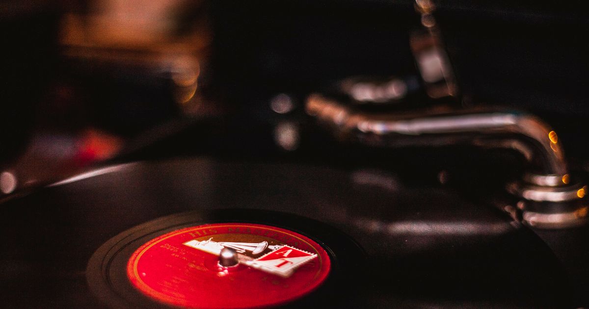 Close-up of a vintage turntable playing a vinyl record, capturing the nostalgic feel of analogue music mediums.