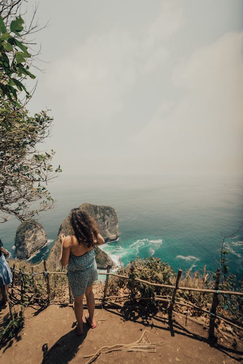 Woman on Hill over Sea Shore