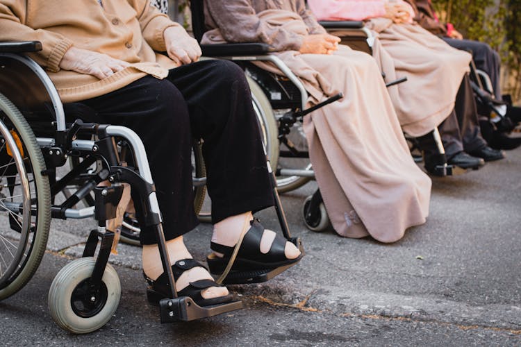 People Sitting On Wheelchairs