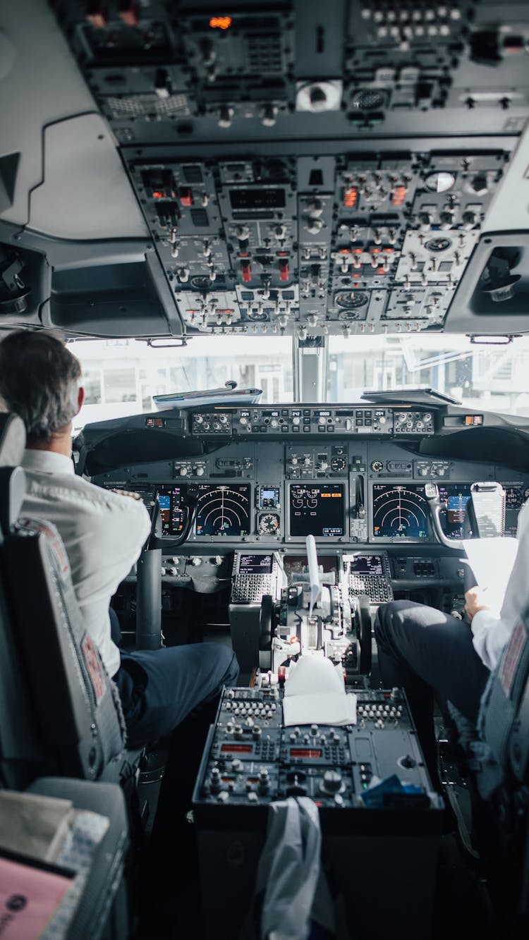 Man Sitting Inside A Cockpit Of An Airplane