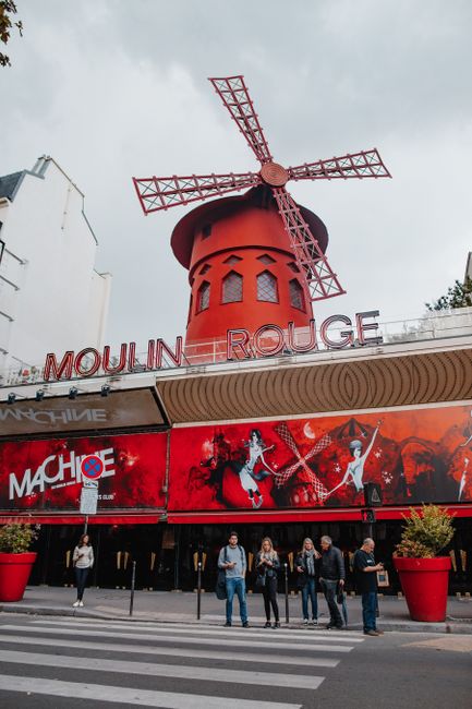 The iconic Moulin Rouge windmill in Paris, France, captured during the day.