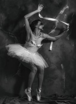 Graceful ballerina posing artistically in monochrome, embodying elegance and poise.