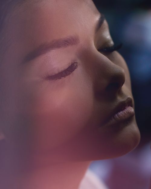 Free Artistic close-up portrait of a woman with closed eyes and soft lighting. Stock Photo