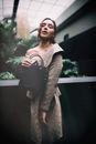 Woman in White and Black Long Sleeve Dress Holding Black Leather Handbag