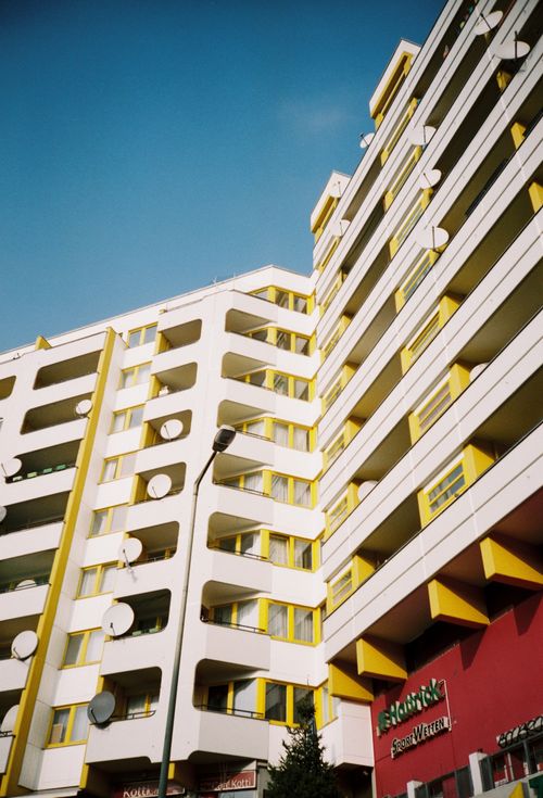 Free Photo of a vibrant architectural building with balconies in Berlin under a clear sky. Stock Photo