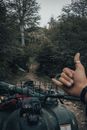 Person Pointing on Green Trees