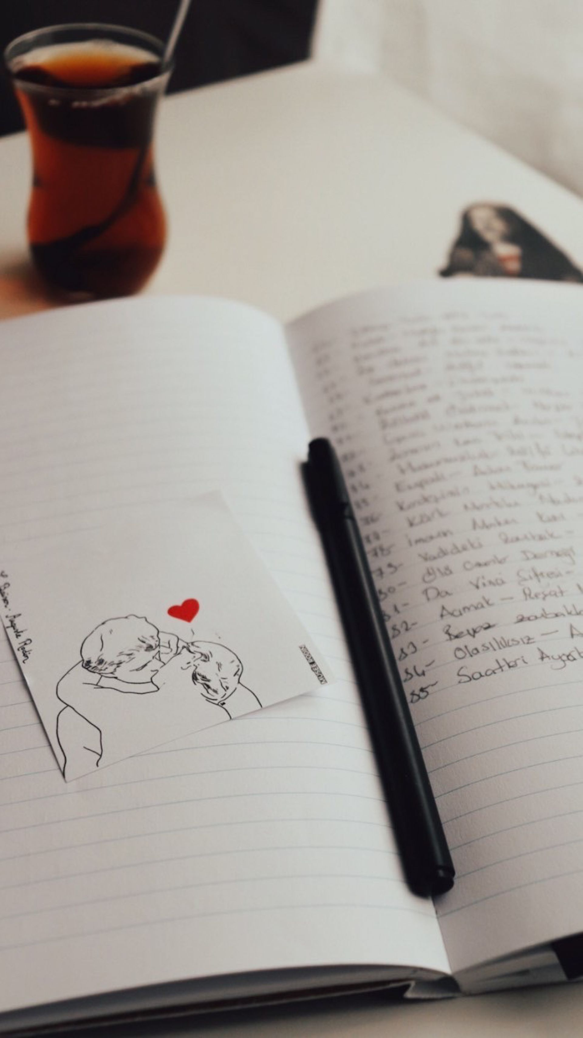 Cup of tea and open journal on a vintage table