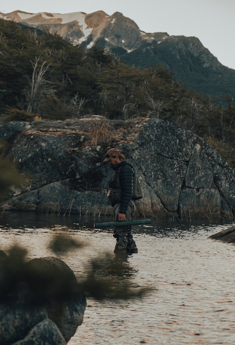 Man Standing In The River And Sampling Water 