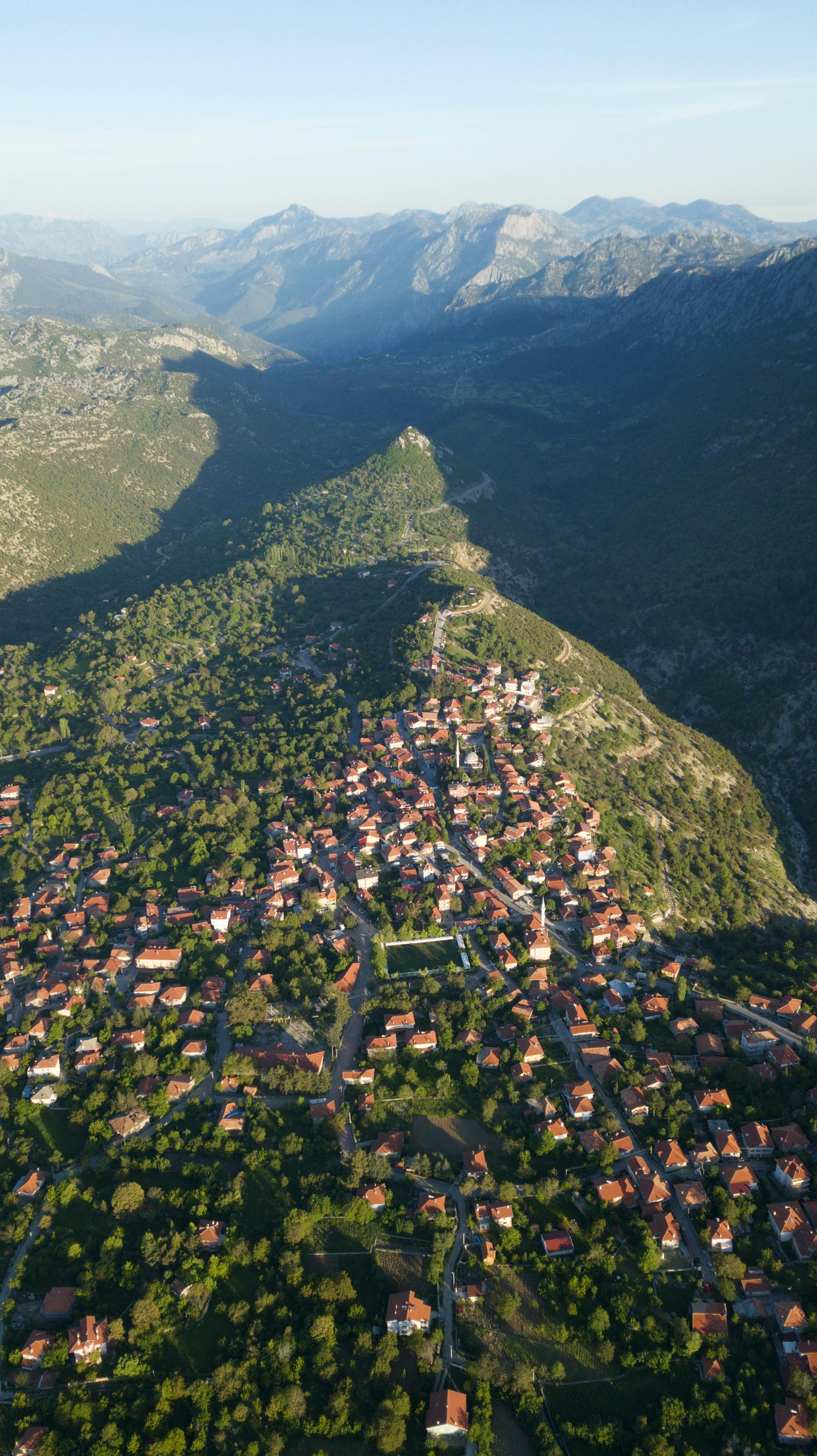 Scenic aerial view of a town nestled in a valley surrounded by mountains.