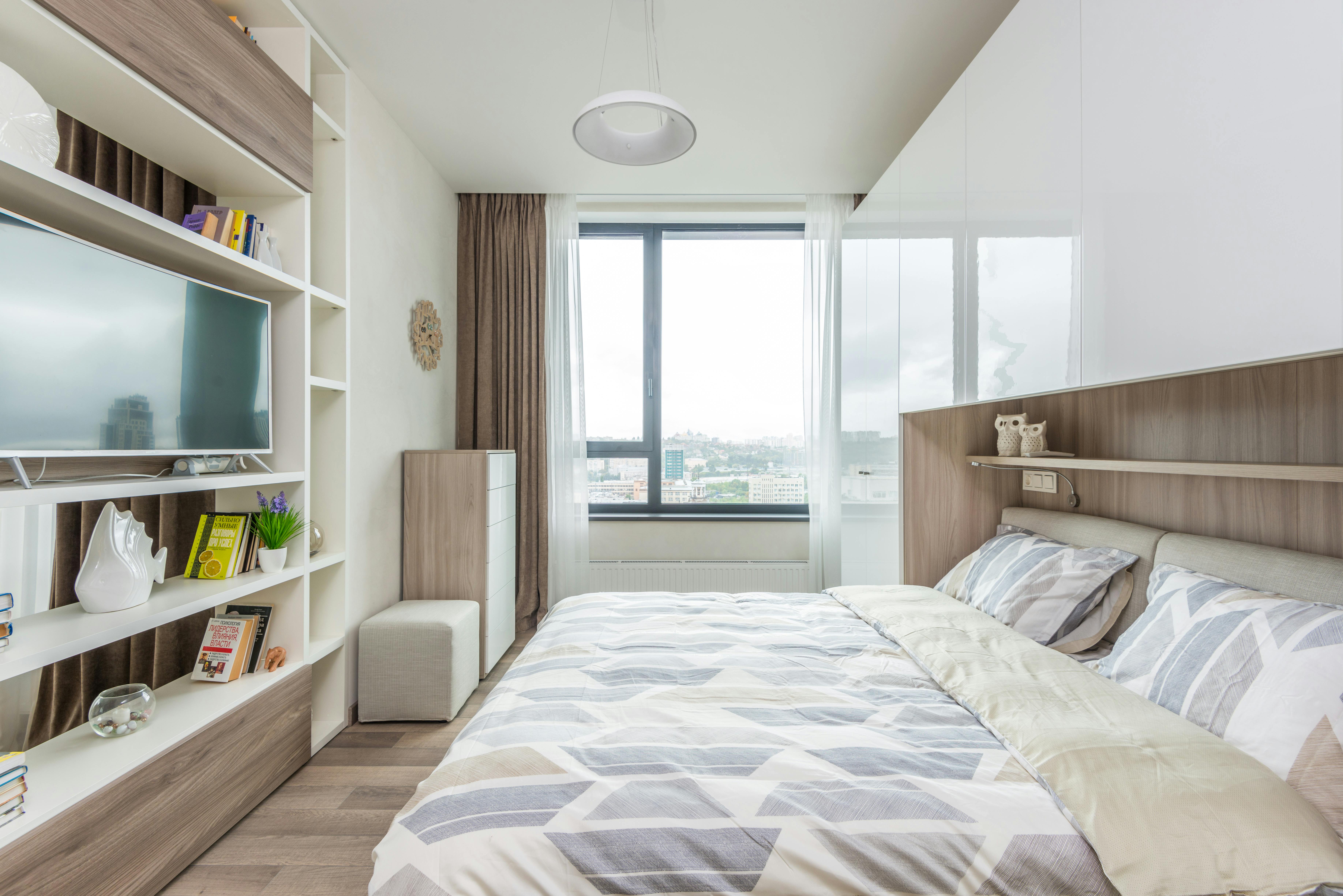 interior of light bedroom with big window