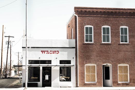 A white storefront with a brick building facade in Marfa, TX.