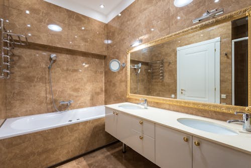 Big mirror hanging above bathroom sinks