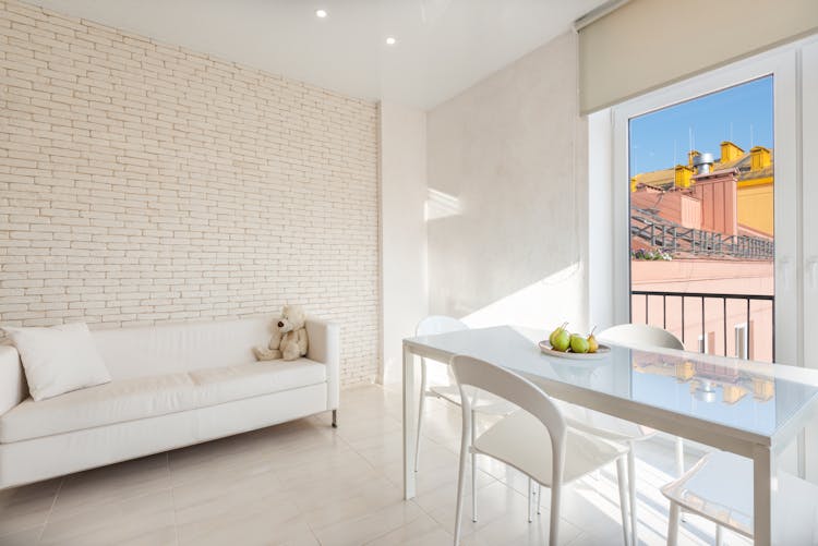 White Sofa And Table With Chairs In Dining Zone