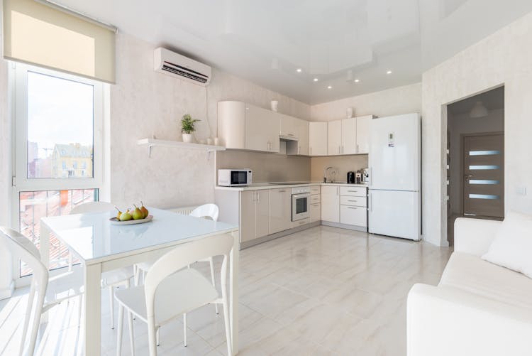 Interior Of Spacious Light Kitchen With Dining Zone