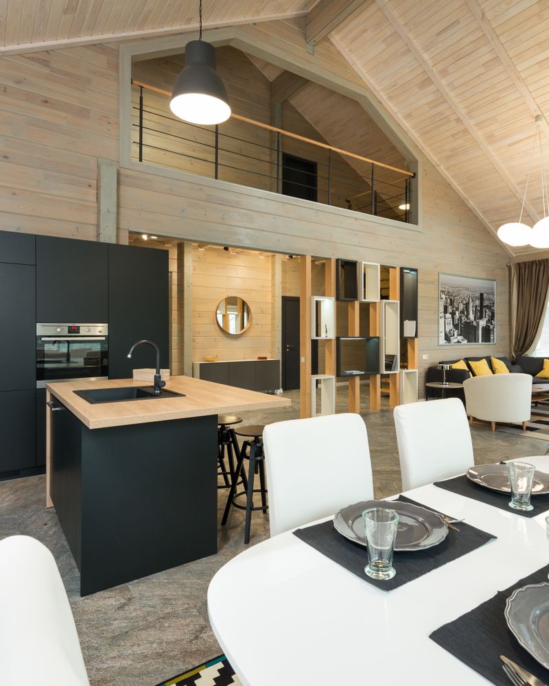 A dining table set for a meal in a bright, open modern kitchen