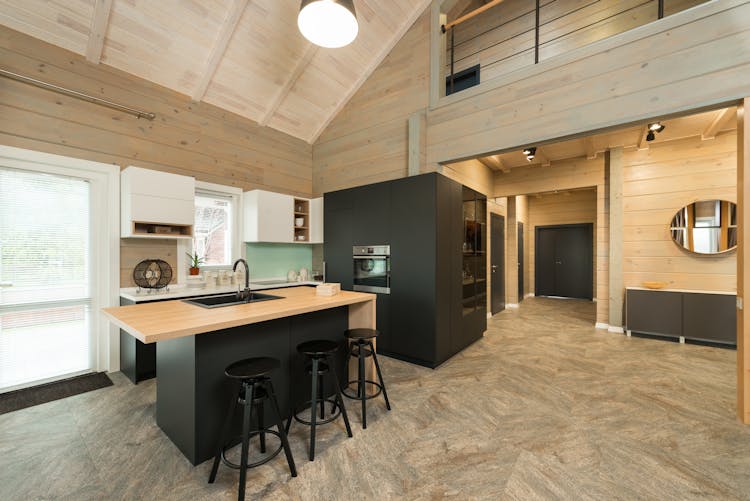 Black Bar Stools Near Brown Wooden Counter Top