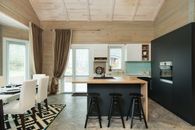 Served dining table and modern kitchen in cottage