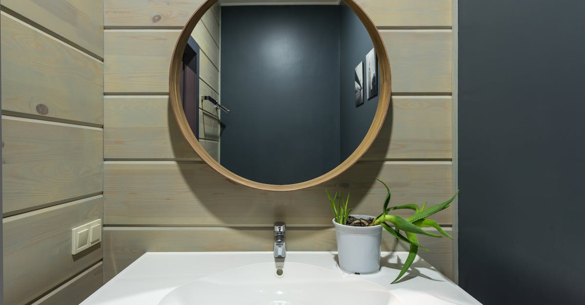 Mirror hanging above sink in bathroom