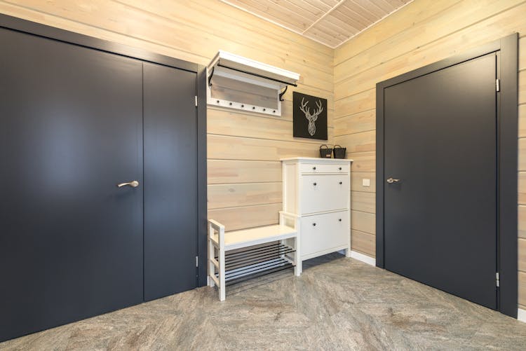 Corridor Furnished With Wooden Cabinet And Shelf Above Shoe Rack