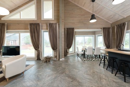 Free Interior design of big house with living room connected with dining zone and kitchen under glowing lamps Stock Photo