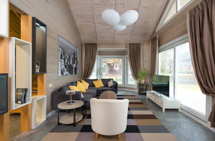 Spacious Living Room With Curtains On Panoramic Windows