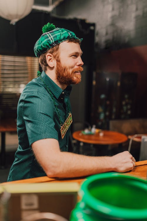 A Bearded Man Wearing Green Polo and a Green and White Cap During Saint Patrick's Day