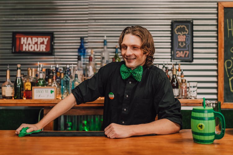 Photo Of A Bartender With A Green Bowtie