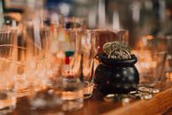 A Close-Up Shot of a little Cauldron with Coins