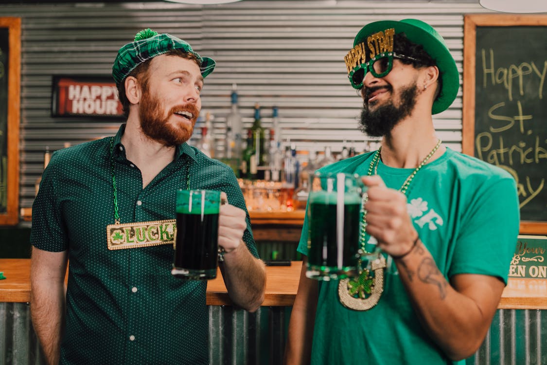 Free Happy diverse guys drinking beer in bar during Saint Patricks Day Stock Photo