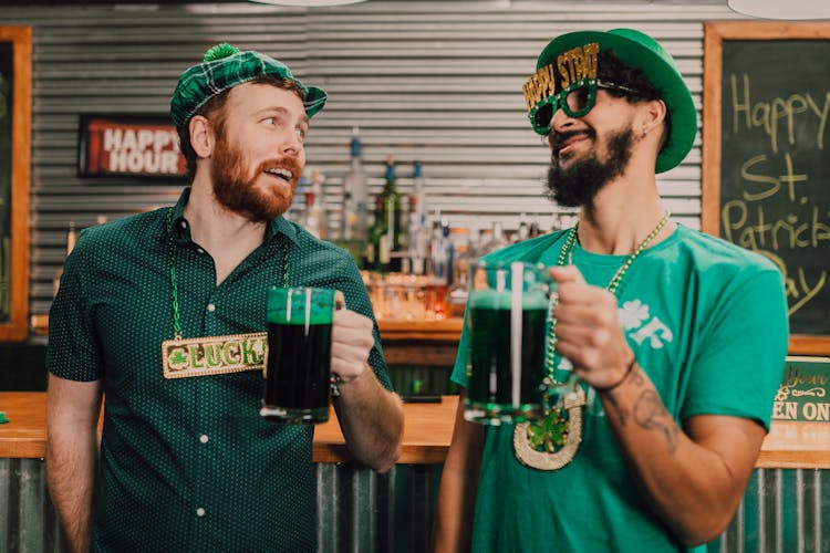 Happy Diverse Guys Drinking Beer In Bar During Saint Patricks Day