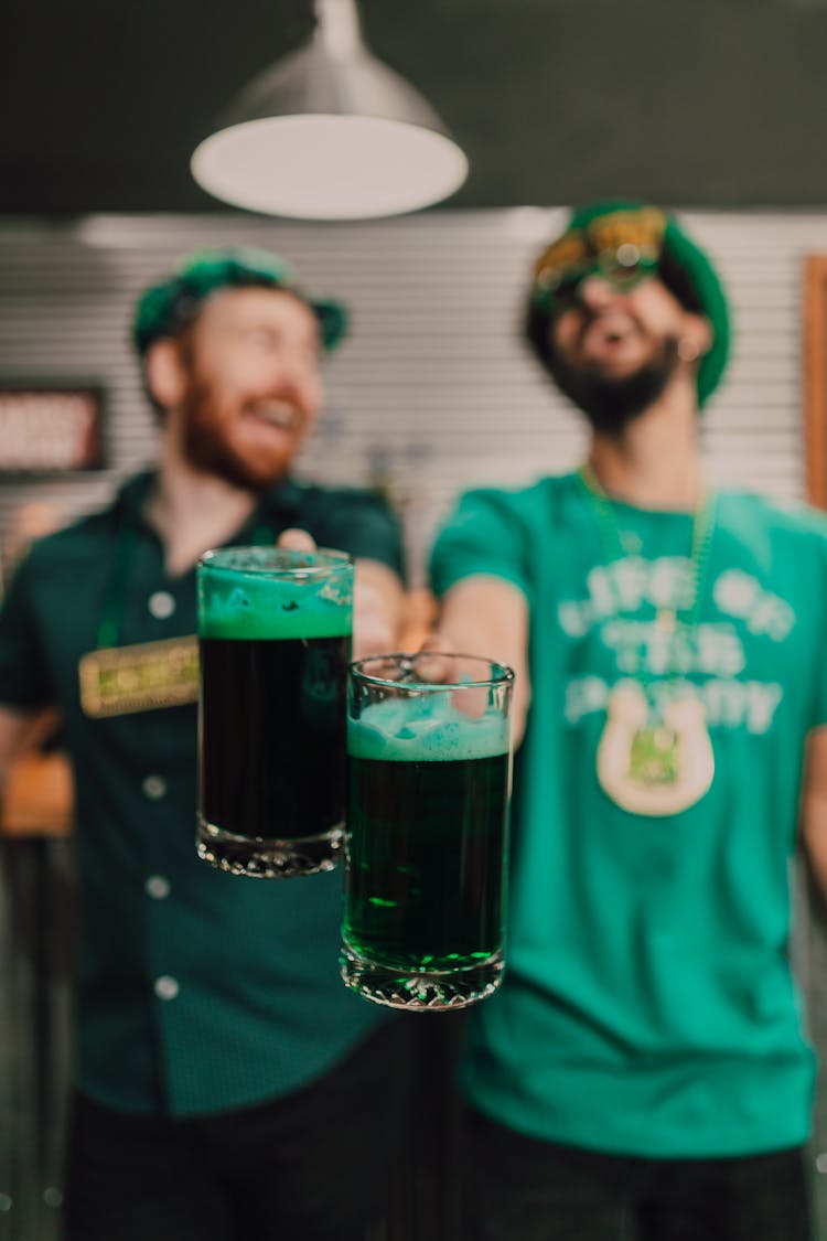 Men Holding Mugs Of Draft Beer