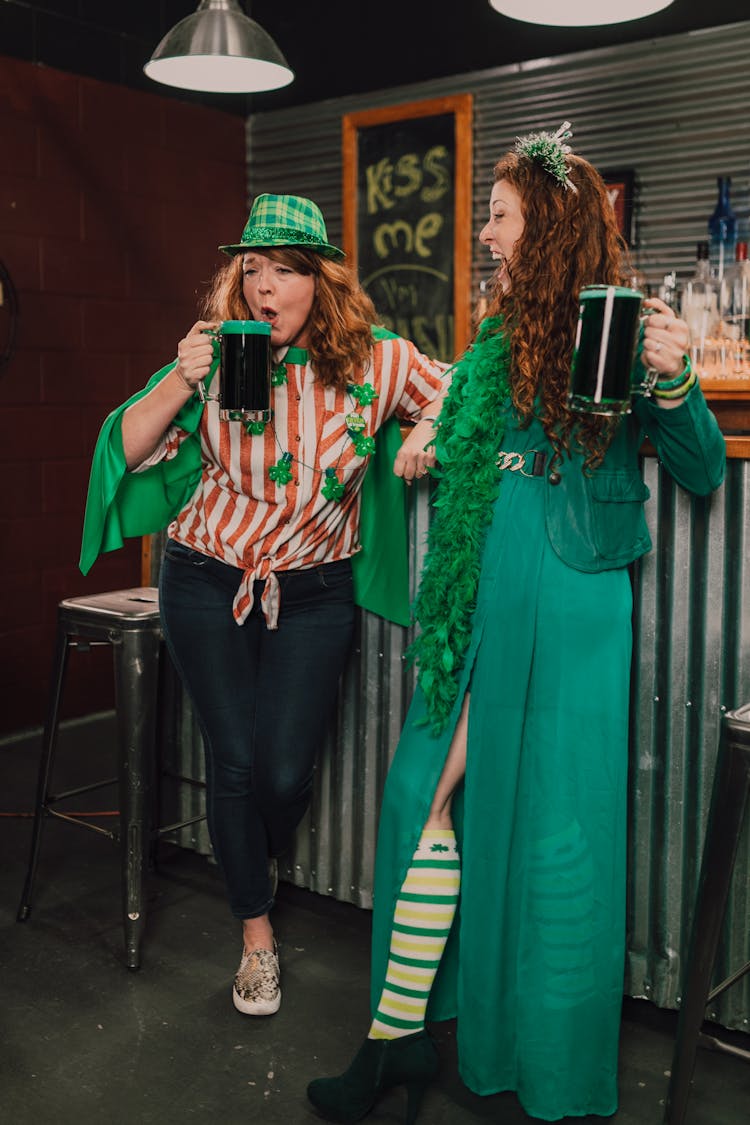 Two Women Drinking In The Bar 