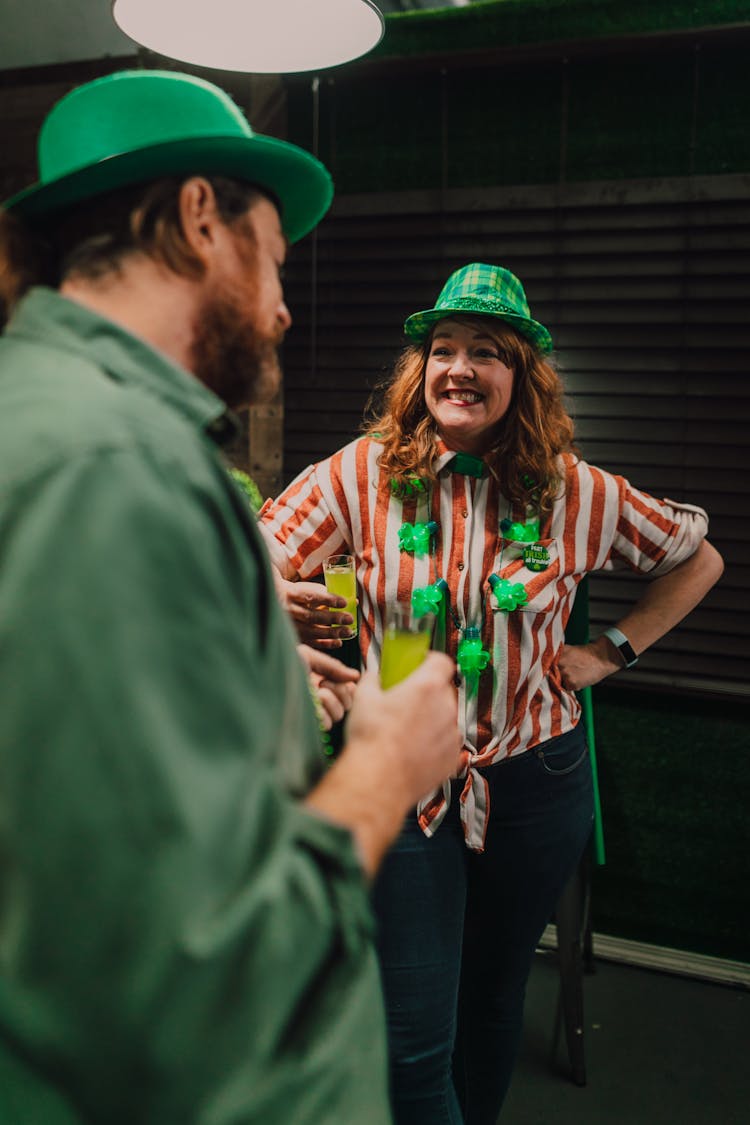 Man And Woman Wearing Green Hats 