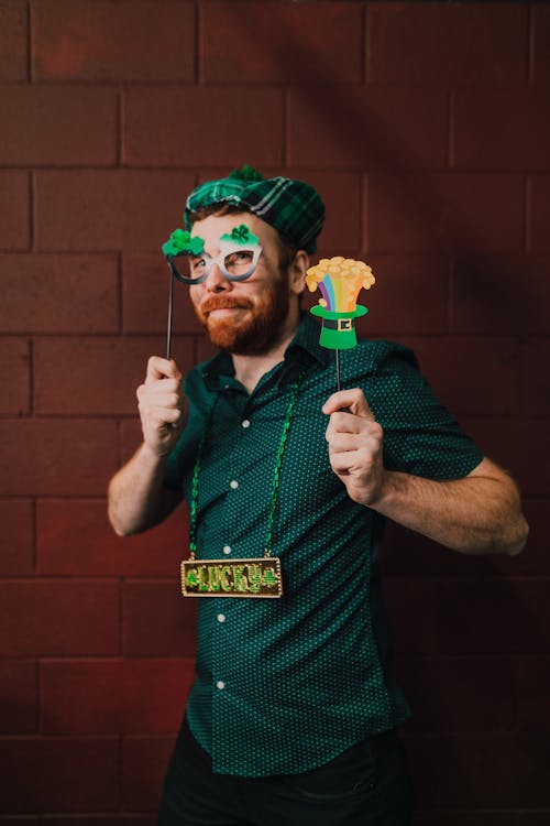 Free Man in Green Polo Holding Props  Stock Photo
