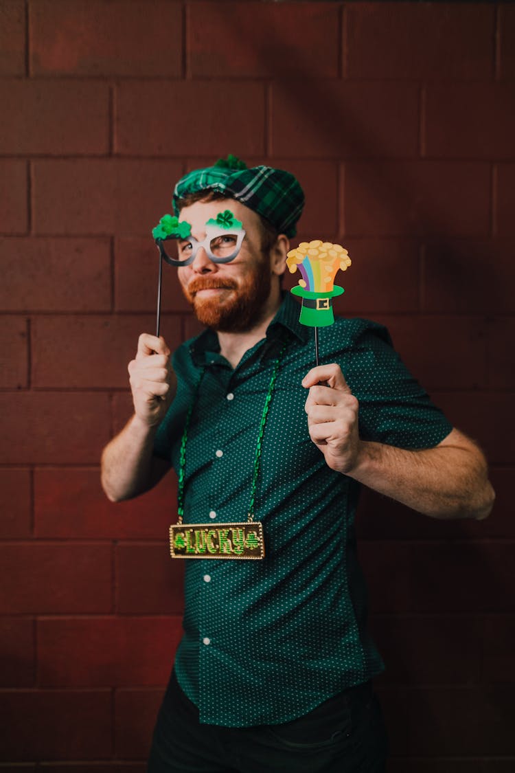 Man In Green Polo Holding Props 