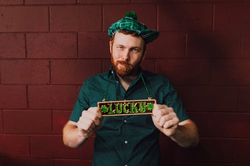 Free A Man Wearing a Tag with the Word Lucky Stock Photo