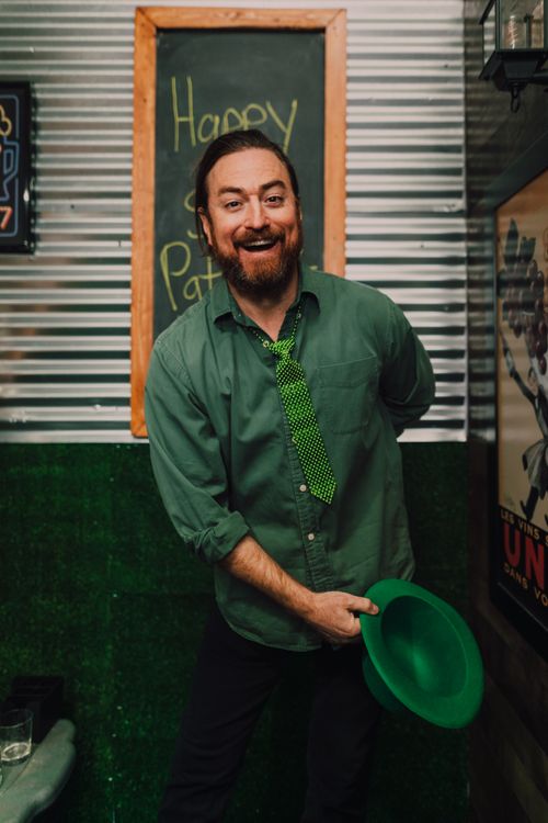 Free Happy man with green hat and tie celebrating St. Patrick's Day indoors. Stock Photo