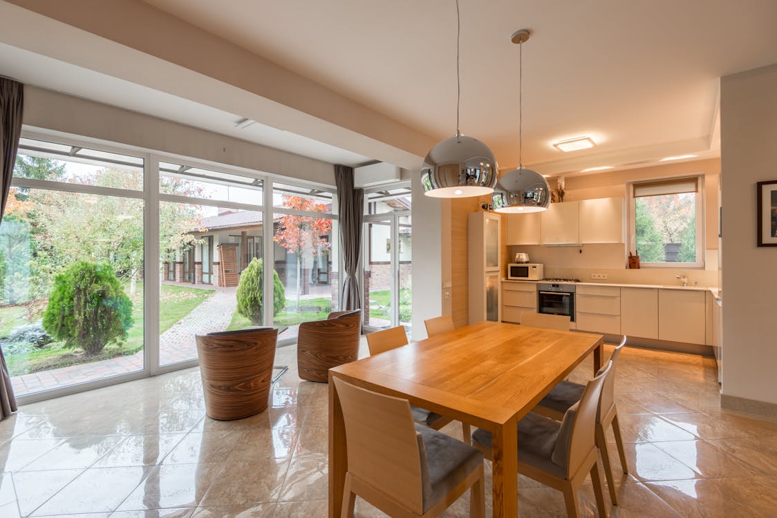 Free Spacious kitchen with dining zone and big windows Stock Photo