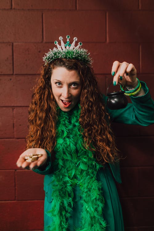 A Woman in Green Dress Holding a Pot of gold