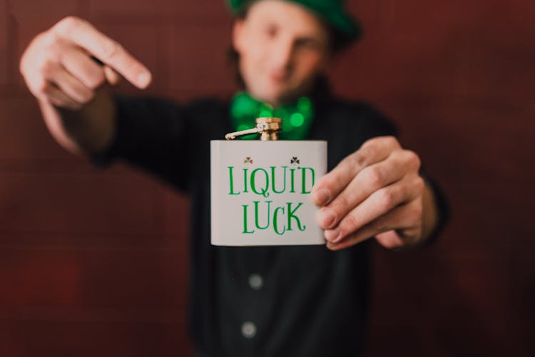 A Man Holding A Hip Flask