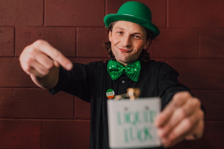 Man Wearing A Green Hat And A Bowtie