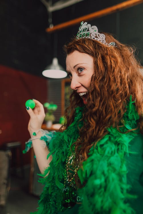 A Woman in Green Costume Playing a Parlor Game