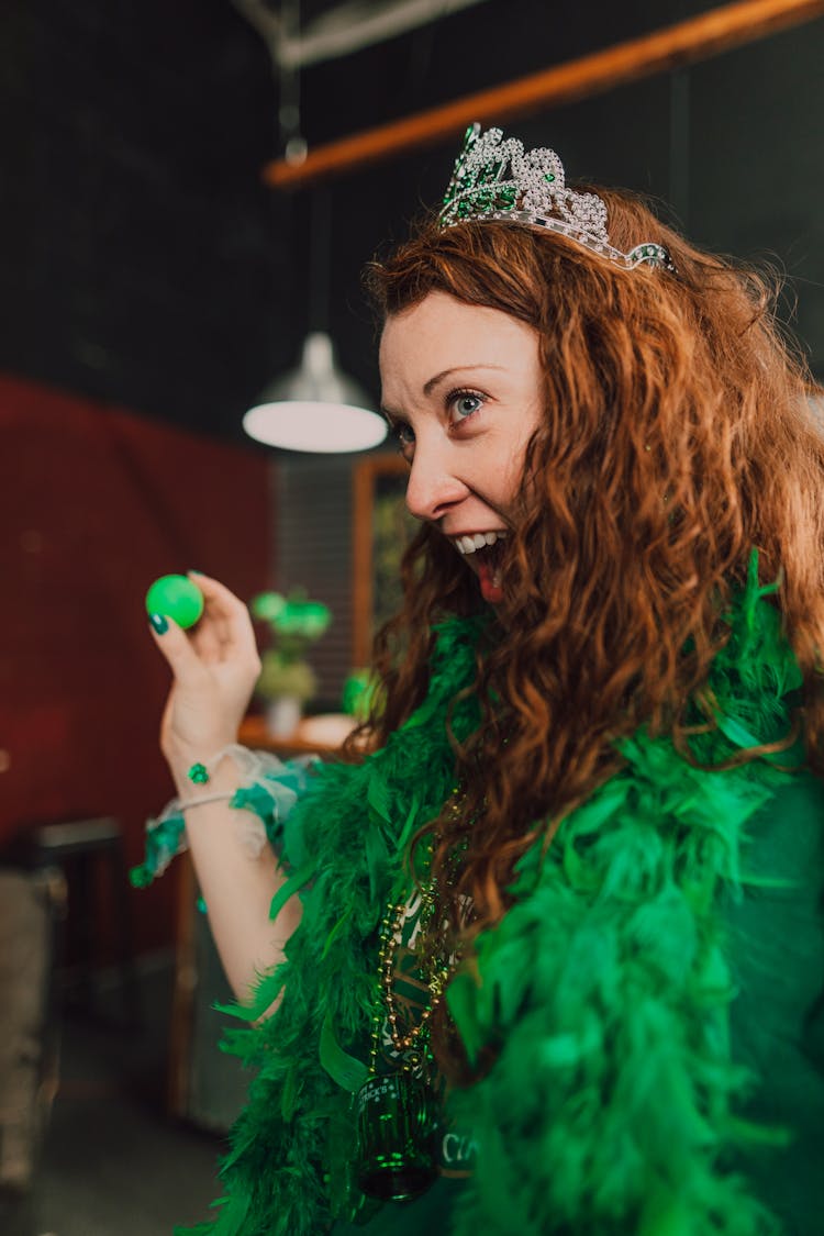 A Woman In Green Costume Playing A Parlor Game