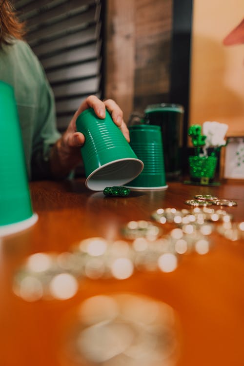 A Person Holding a Green Plastic Cup
