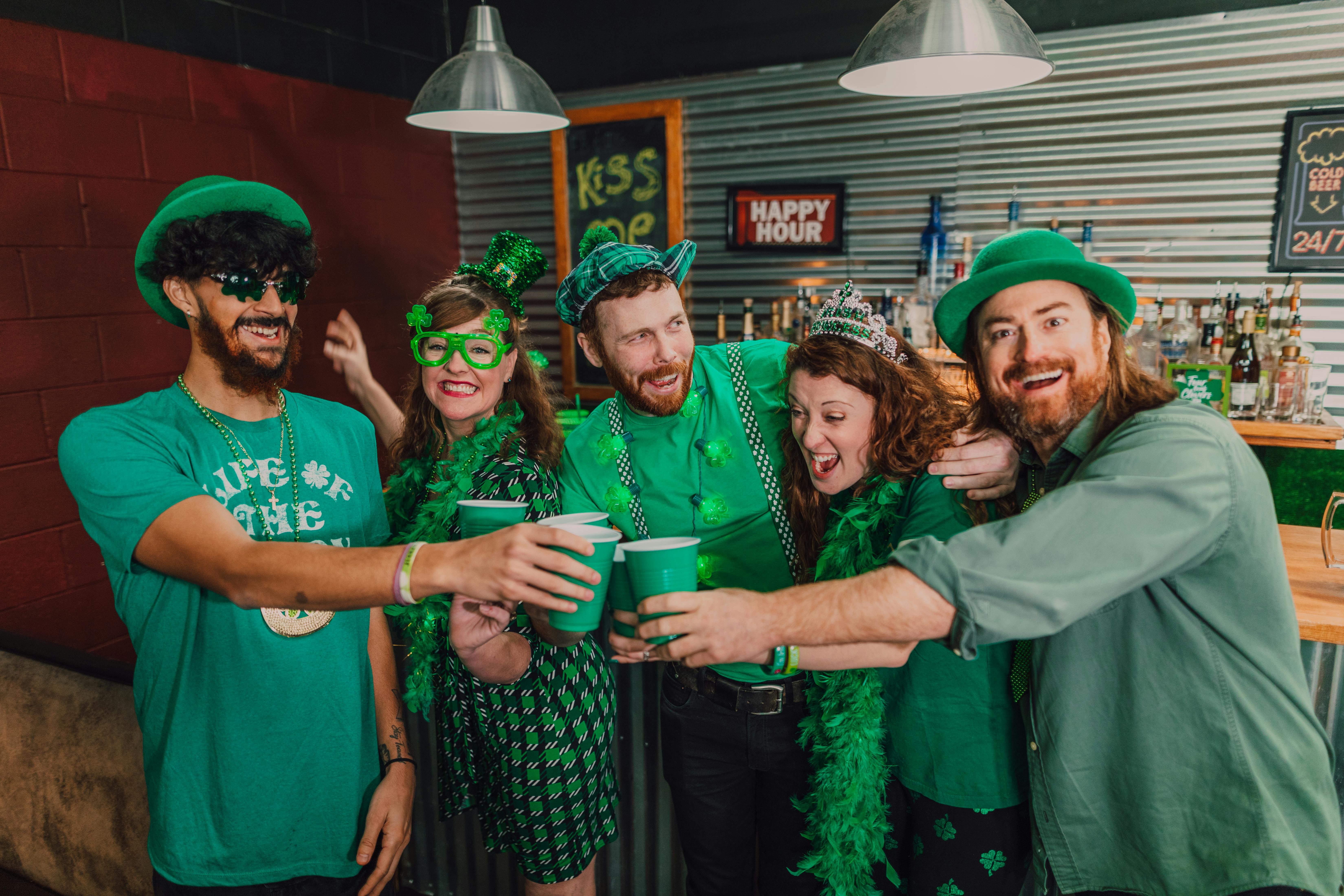 group of people wearing green shirts